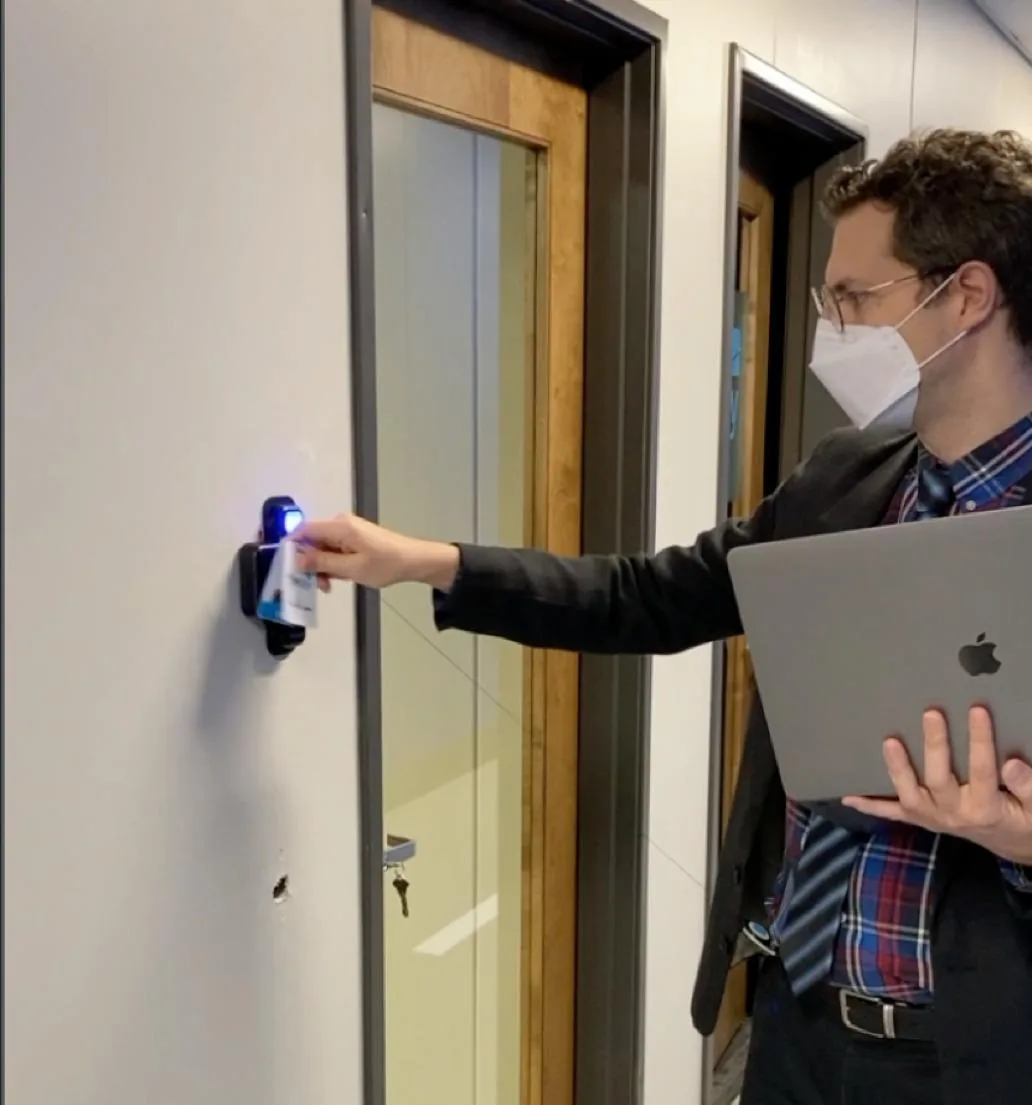 Worker scanning an RFID card — the shared, losable credential PalmClock replaces