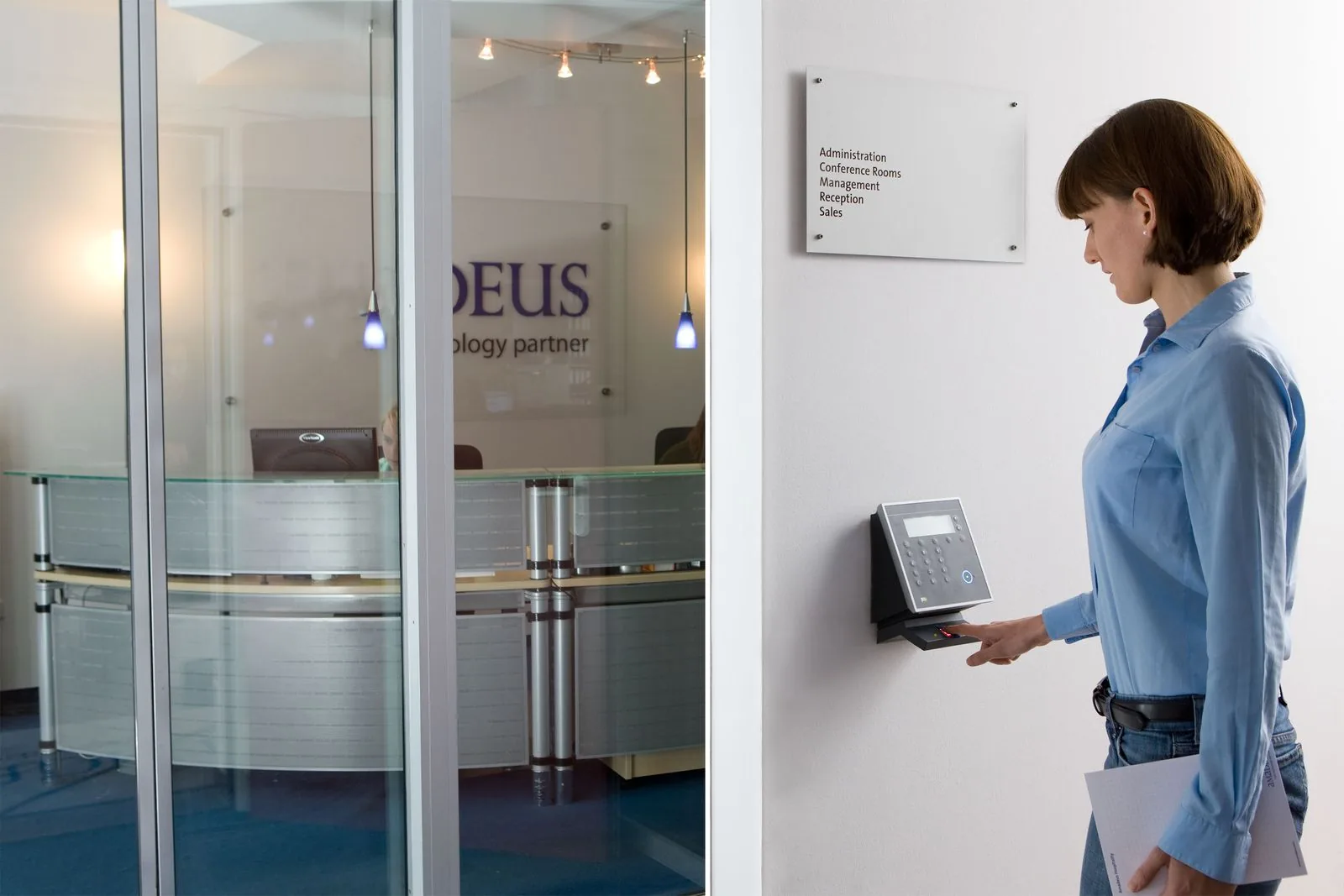 A woman verifying her identity at a contactless access reader